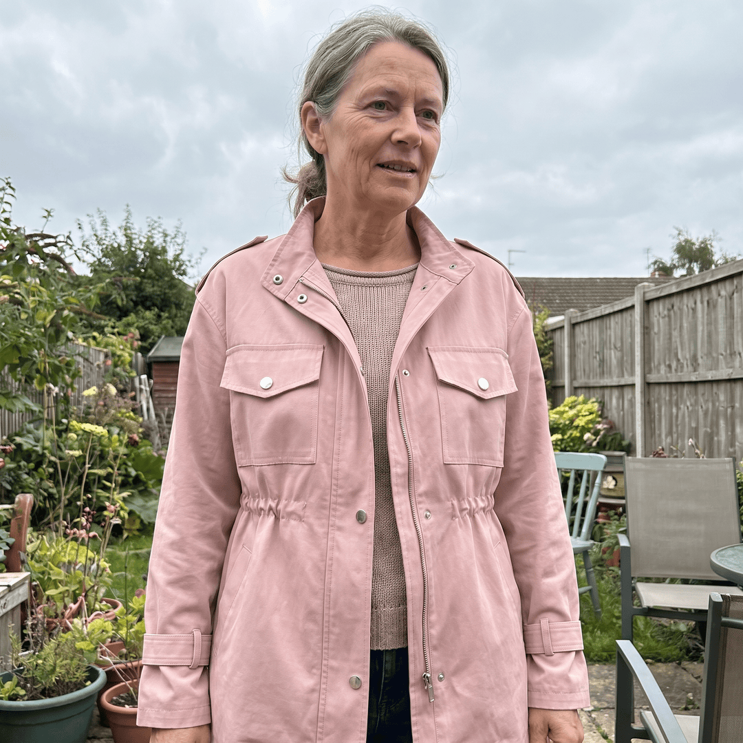 Pink overcoat on model with stand collar and flap chest pockets