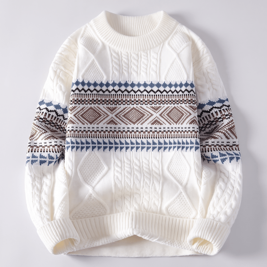 White crew-neck cable knit sweater with navy and brown Nordic fair isle stripe pattern