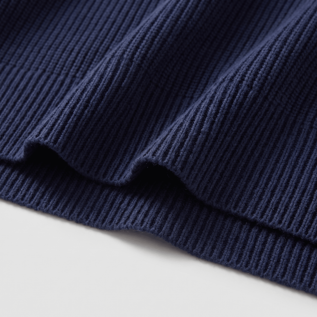 Dark navy ribbed knit hem and cuff detail on crewneck pullover sweater
