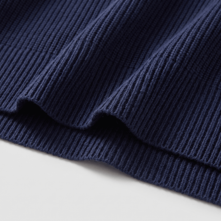 Dark navy ribbed knit hem and cuff detail on crewneck pullover sweater