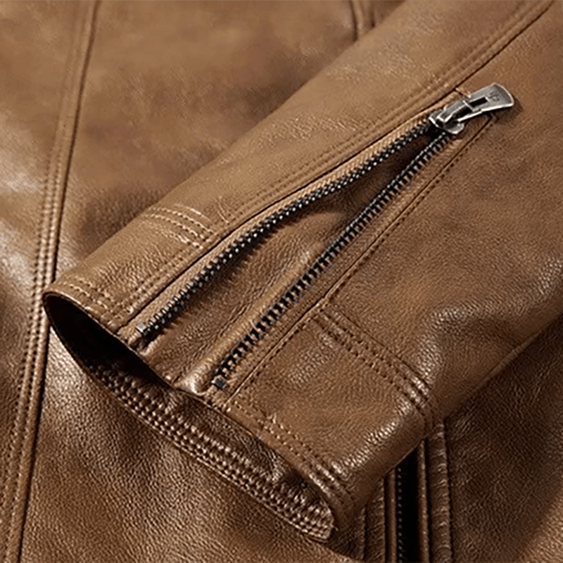 Cigar brown leather jacket sleeve close-up with zipper pocket and stitched seam