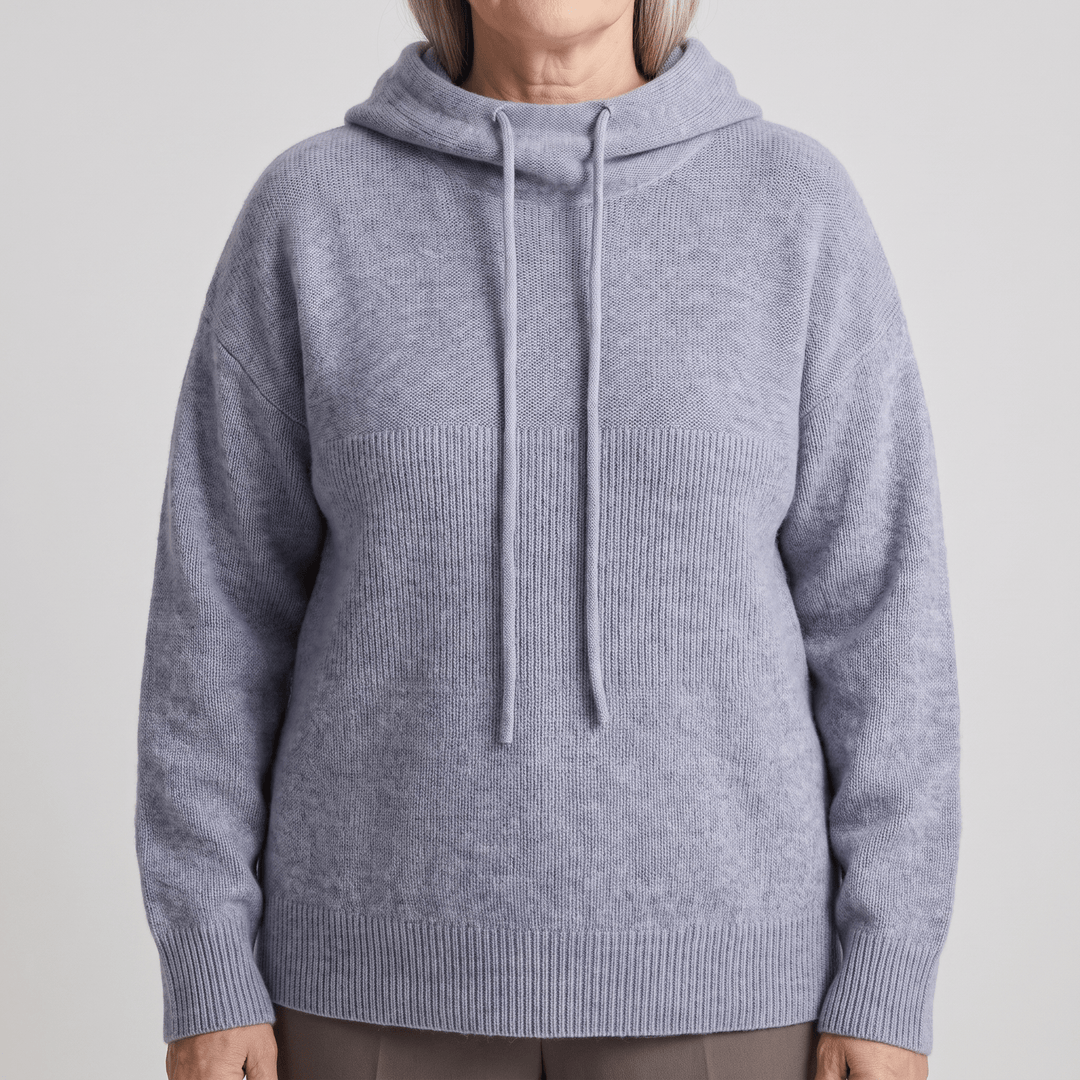 Light blue knitted pullover hoodie with drawstring hood and ribbed cuffs.