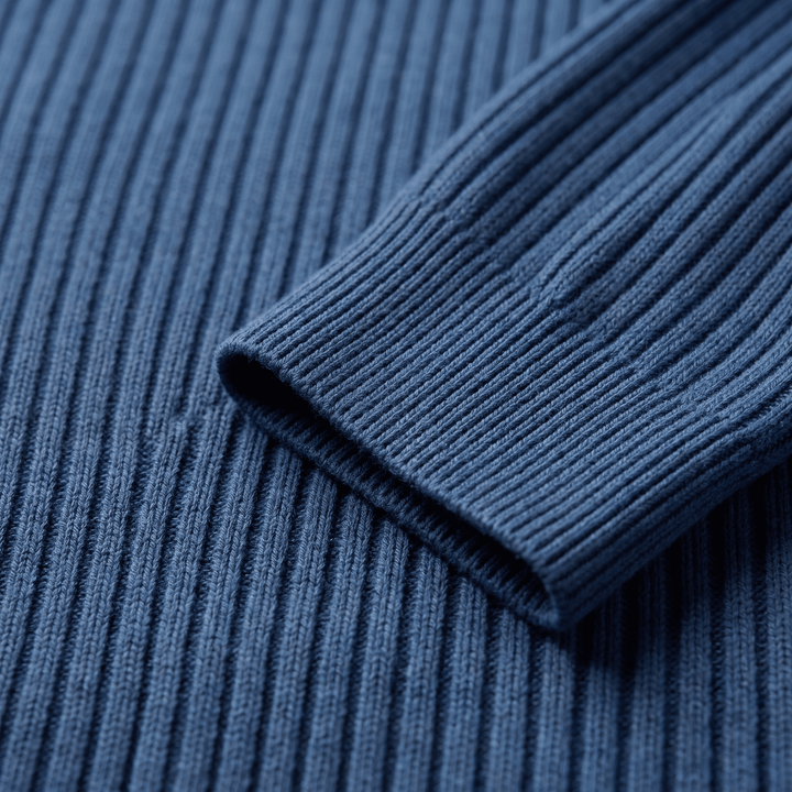 Blue ribbed knit sleeve cuff close-up with textured vertical knit lines.