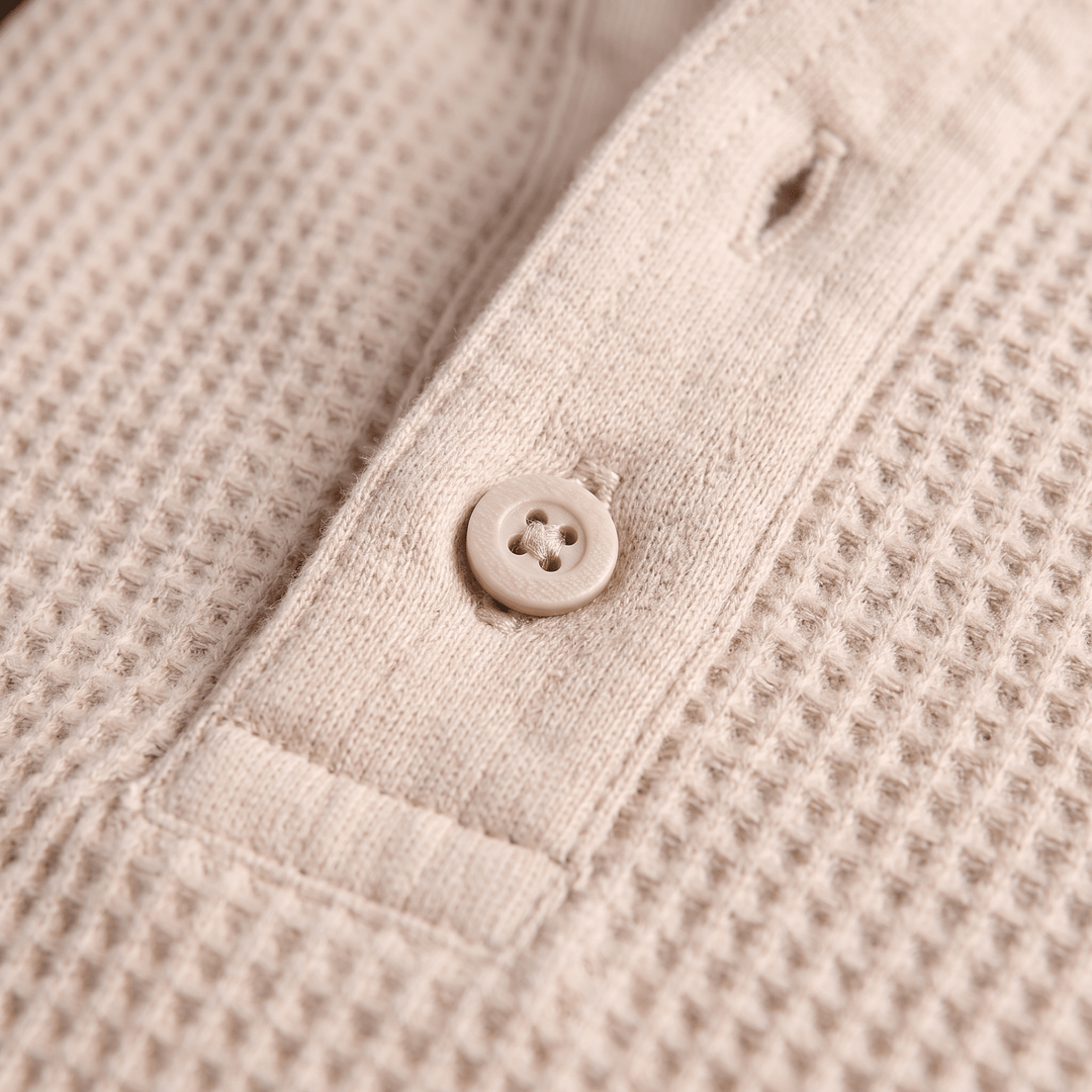 Beige waffle-knit henley placket with single visible button detail