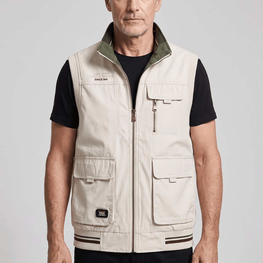 Men's reversible utility vest, cream with green collar and zip front, multiple pockets.