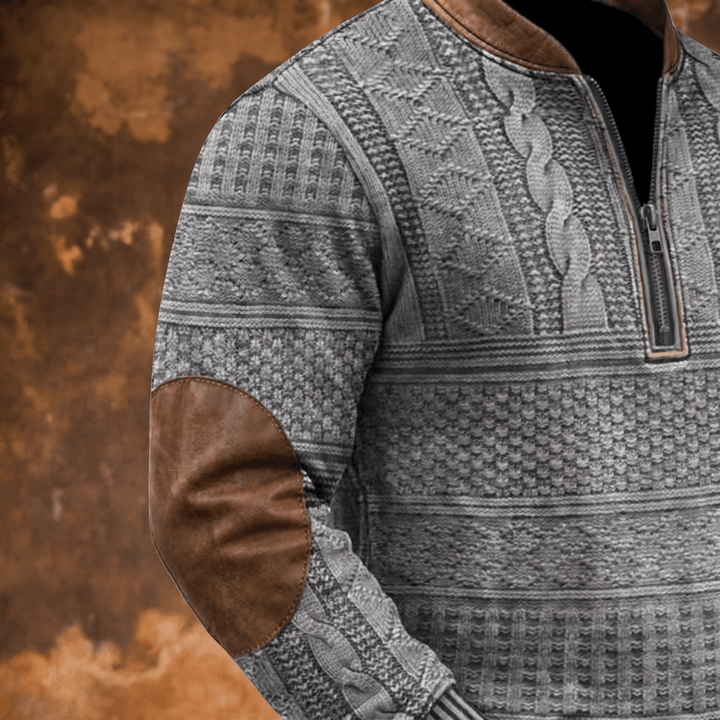 Grey zip-up knit jumper sleeve detail with brown leather-look elbow patch
