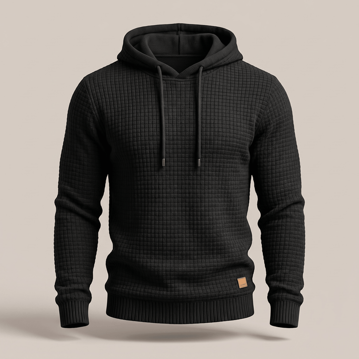 Black waffle-knit hoodie with adjustable drawstring hood, kangaroo pocket, ribbed cuffs and hem