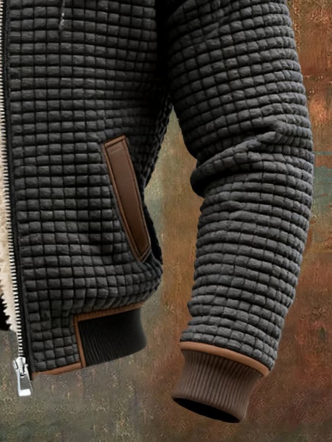 Dark grey quilted hooded jacket detail with sherpa lining, zip, and brown pocket trim
