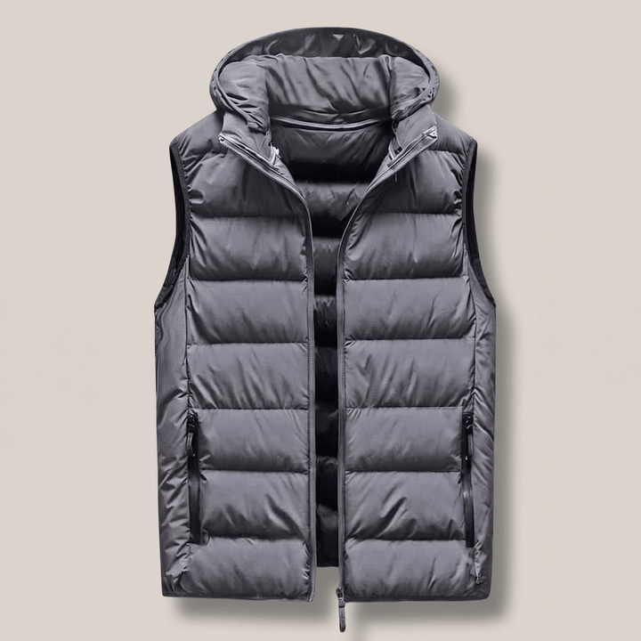 Grey hooded puffer vest with full front zipper and quilted baffle quilting, side pockets