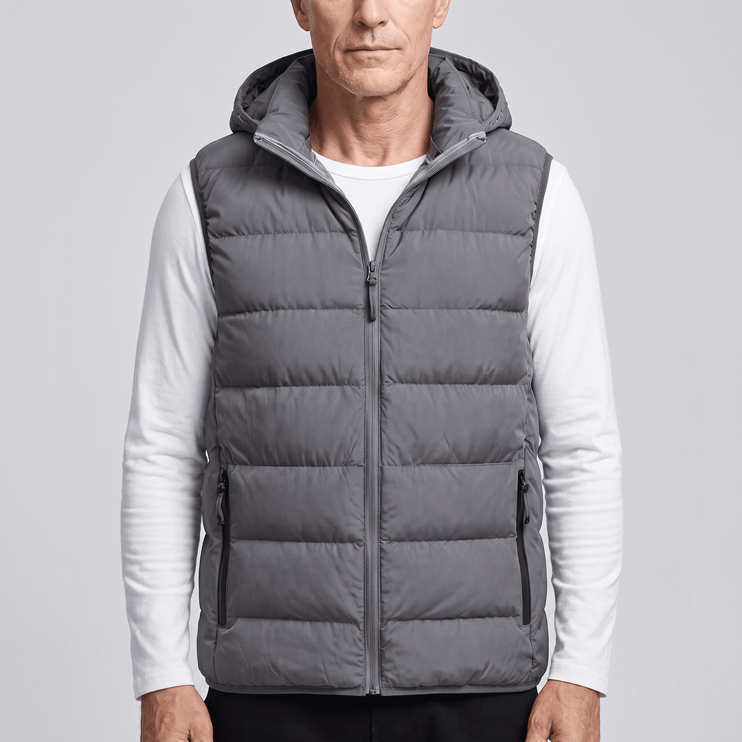 Dark grey puffer vest with full-length zipper, sleeveless insulated design, side pockets