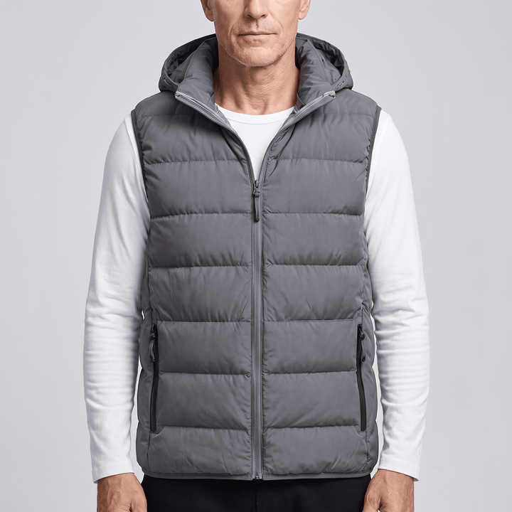 Dark grey puffer vest with full-length zipper, sleeveless insulated design, side pockets
