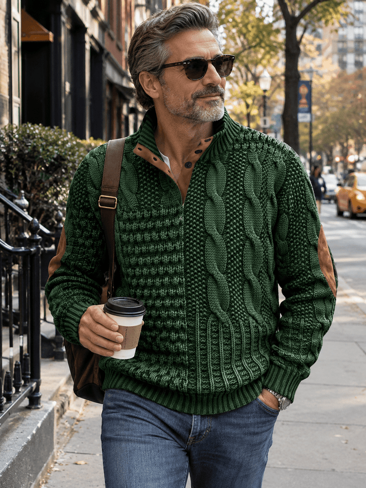 Green cable-knit warm pullover sweater worn with blue jeans, ribbed collar and cuffs
