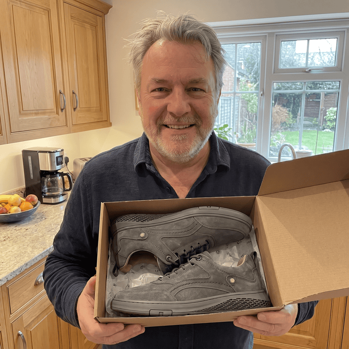Mystery box with gray low-top sneakers in a cardboard box
