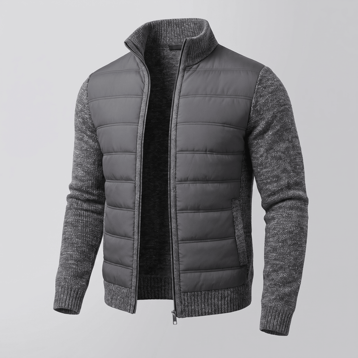 Dark grey quilted jacket with textured knit sleeves, full zip front, ribbed cuffs