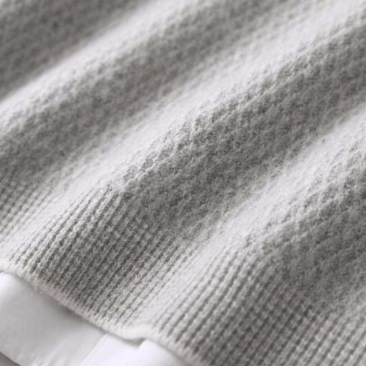 THEO cashmere sweater, close-up of ribbed hem and textured knit, heather grey