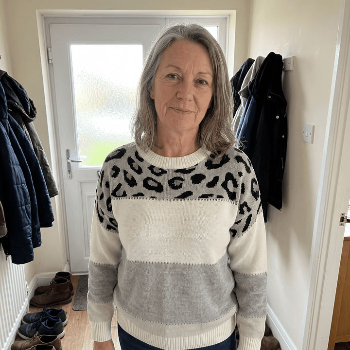 Leopard print sweater in cream and grey with black spots, worn with long sleeves
